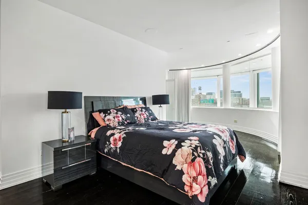 a bedroom with a bed and glass table