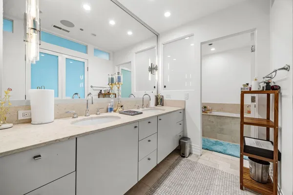 a bathroom with a double vanity sink and mirror