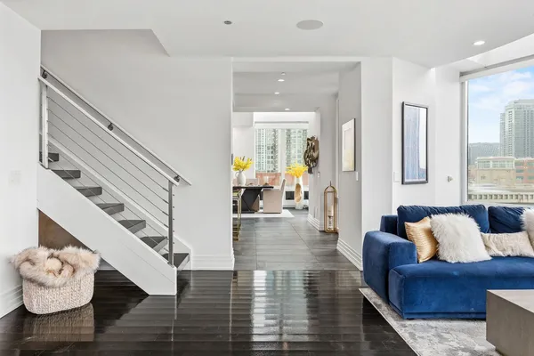 a living room with furniture and wooden floor