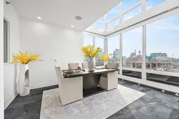 a view of living room with kitchen island granite countertop furniture and a potted plant