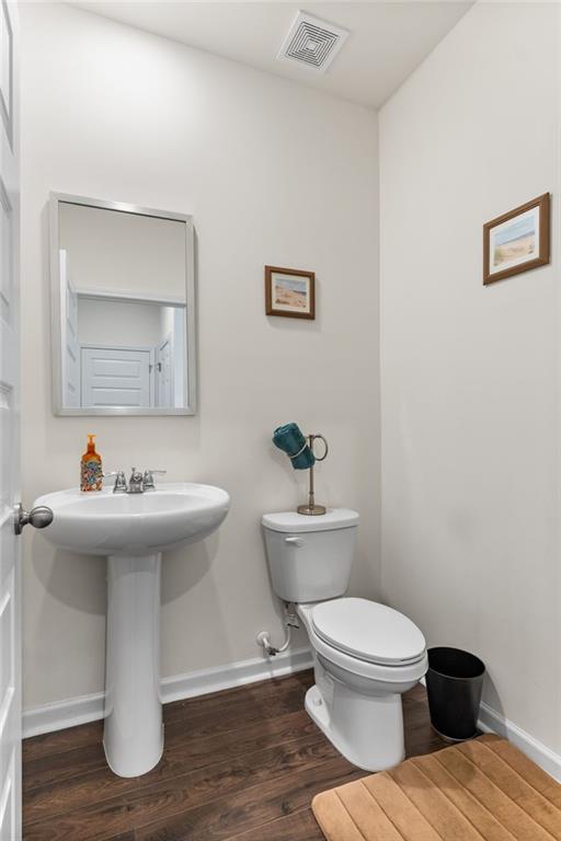 104 Waratah Drive Locust Grove, GA 30248 - Photo 12 of 27 a bathroom with a toilet sink and mirror