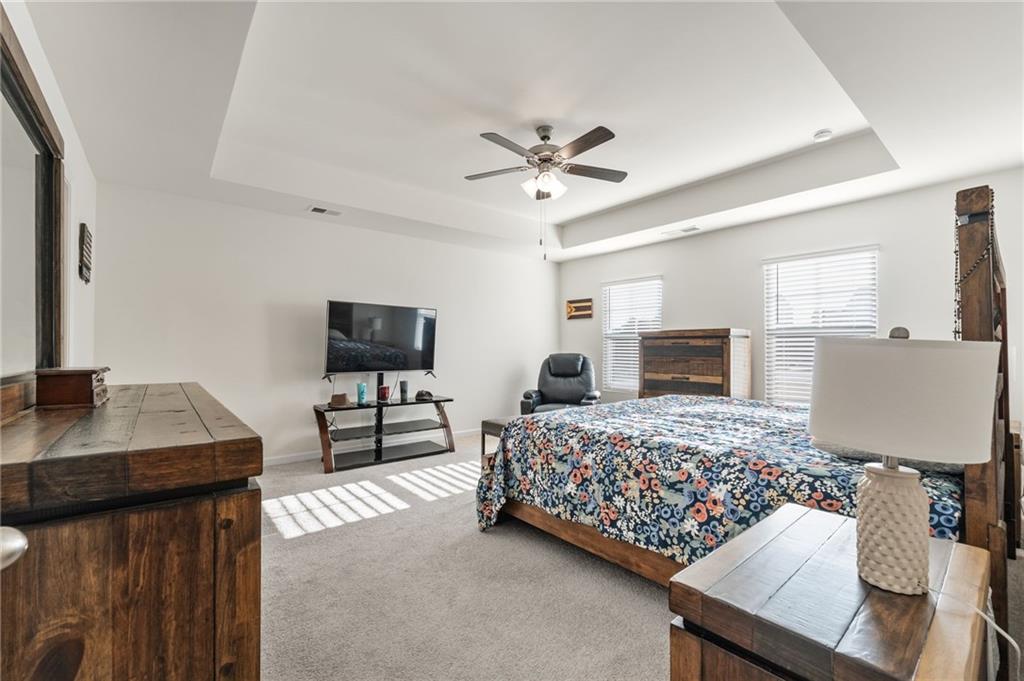 104 Waratah Drive Locust Grove, GA 30248 - Photo 13 of 27 a bedroom with a bed and a flat screen tv