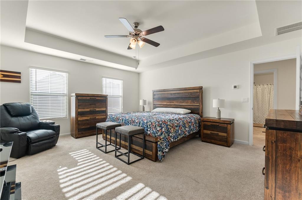 104 Waratah Drive Locust Grove, GA 30248 - Photo 14 of 27 a bedroom with a bed a couch and dresser