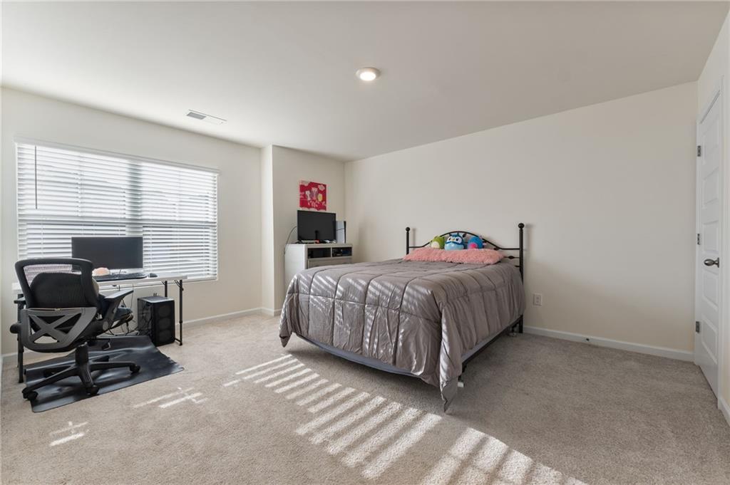 104 Waratah Drive Locust Grove, GA 30248 - Photo 18 of 27 a bedroom with a bed and a window