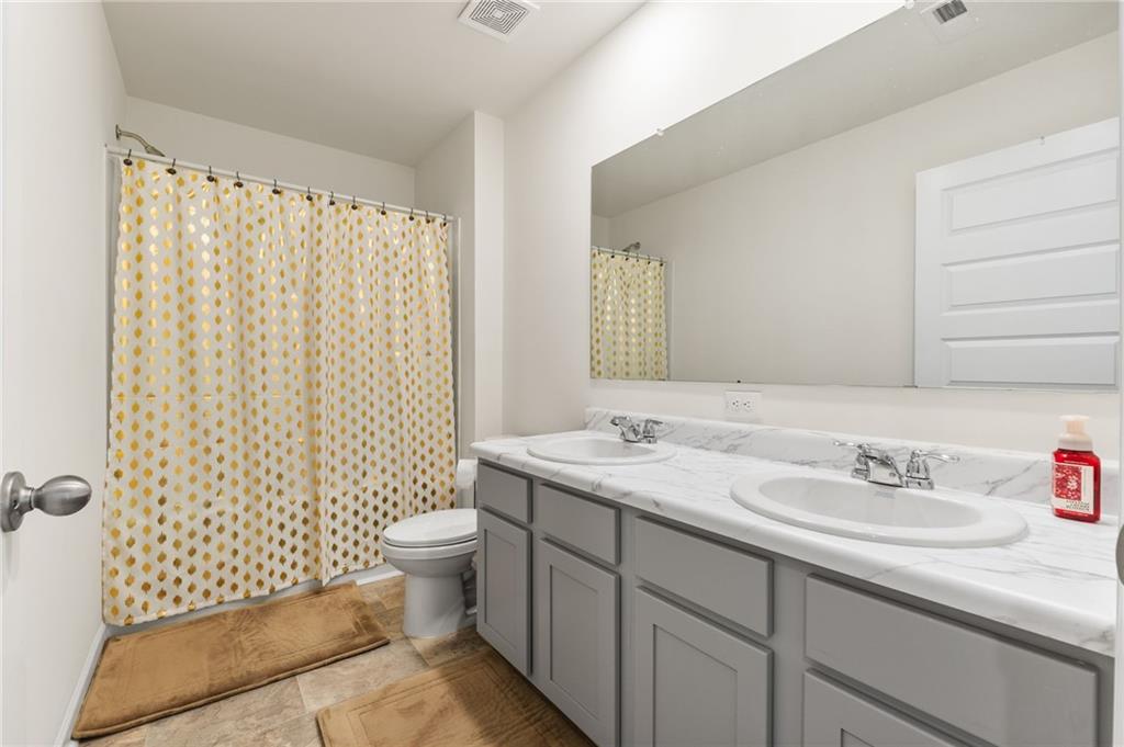 104 Waratah Drive Locust Grove, GA 30248 - Photo 19 of 27 a bathroom with a sink toilet and shower