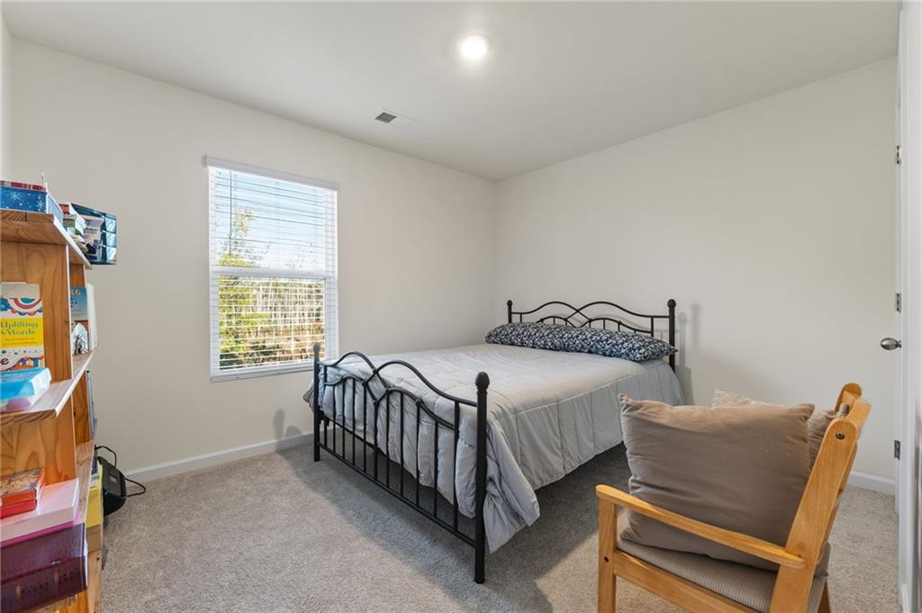 104 Waratah Drive Locust Grove, GA 30248 - Photo 20 of 27 a bedroom with a bed and a window