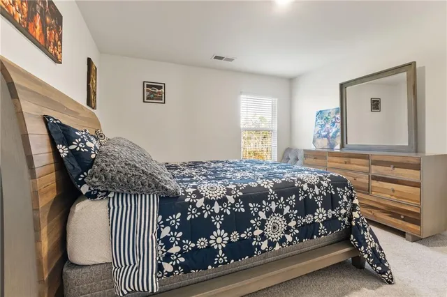 a bedroom with a bed and a desk in it