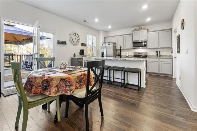 a large kitchen with kitchen island a dining table and chairs