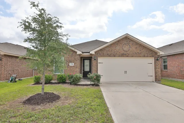 a view of a house with a yard and garage