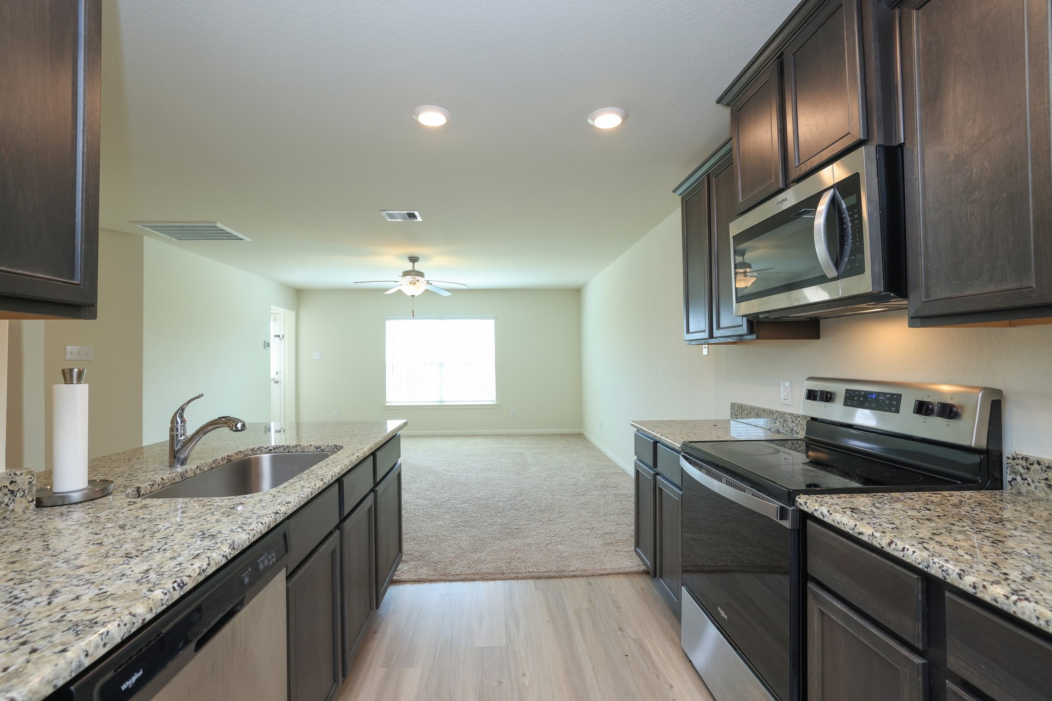 20914 Solstice Point Drive Hockley, TX 77447 - Photo 14 of 27 a kitchen with granite countertop cabinets stainless steel appliances and a sink