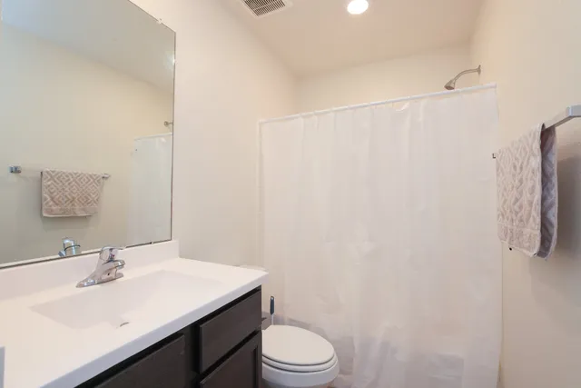 a bathroom with a sink toilet and vanity
