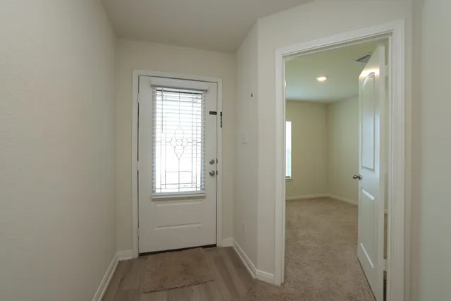 an empty room with windows and closet
