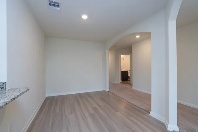 a view of a room with wooden floor and fence