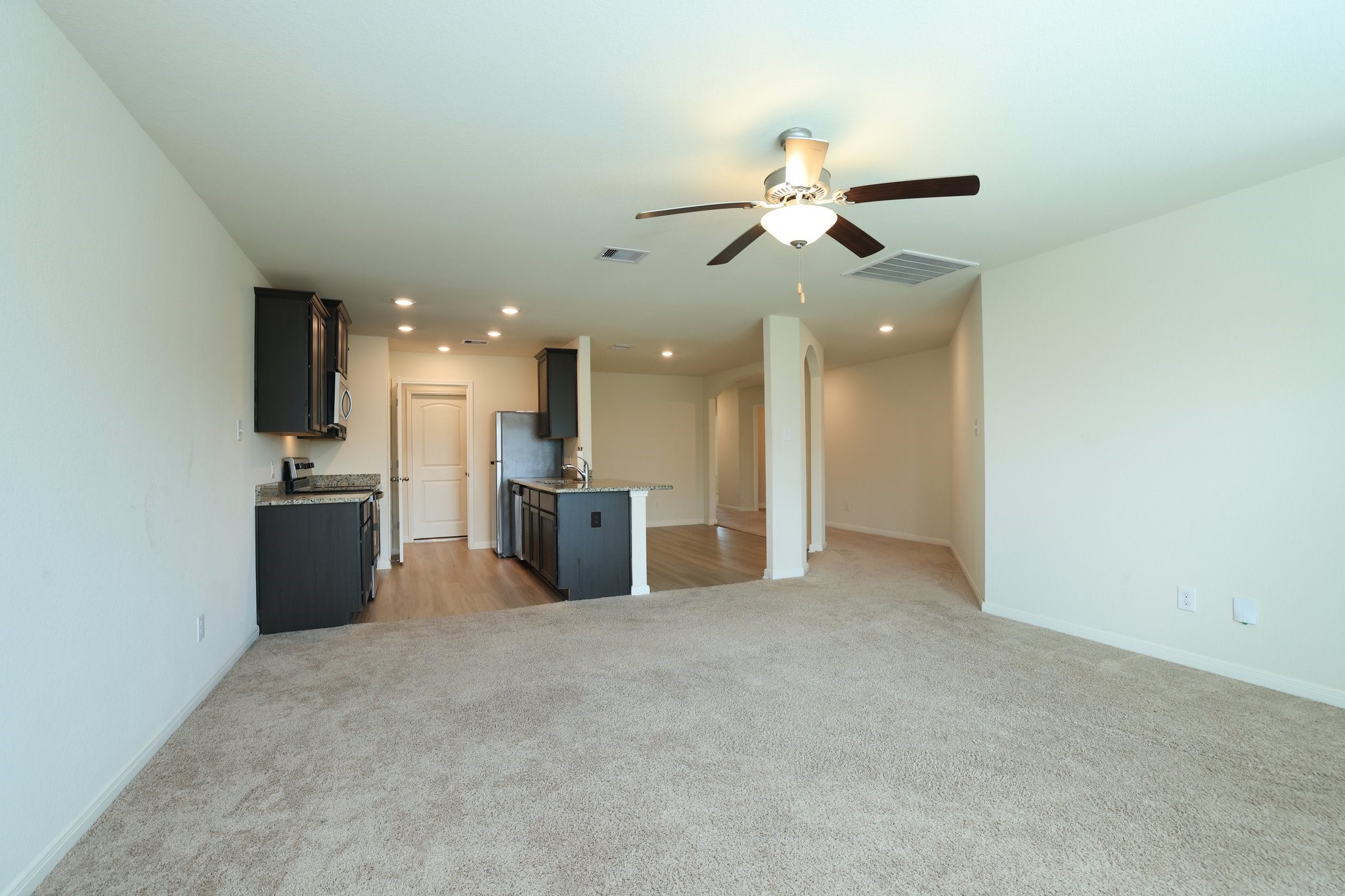 20914 Solstice Point Drive Hockley, TX 77447 - Photo 8 of 27 a view of a kitchen with a sink and a refrigerator