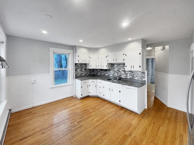 80 Delmont Avenue Worcester, MA 01604 - Photo 16 of 35 a kitchen with stainless steel appliances white cabinets and wooden floors