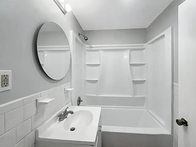 a bathroom with a sink a mirror and a bathtub