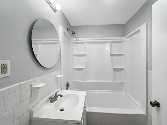 80 Delmont Avenue Worcester, MA 01604 - Photo 17 of 35 a bathroom with a sink a mirror and a bathtub