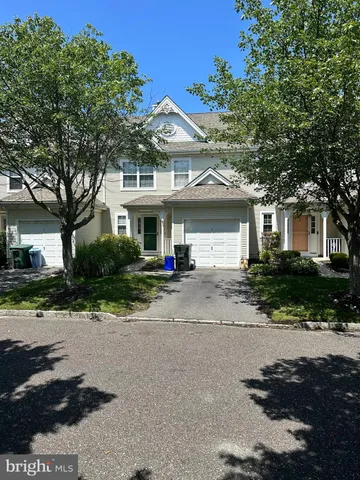 a front view of a house with a yard and a garage