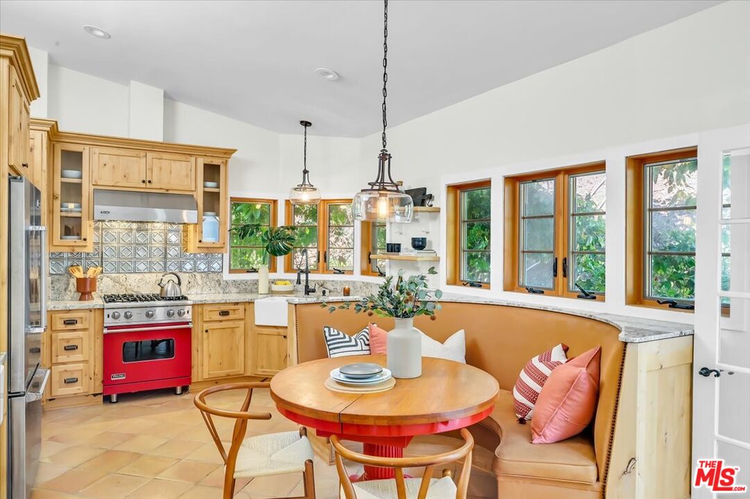a dining room with stainless steel appliances kitchen island granite countertop a dining table and chairs