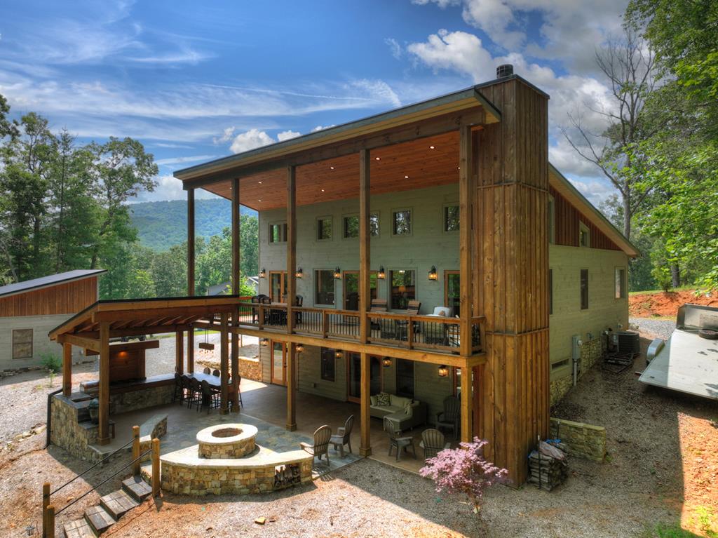 a view of a patio with table and chairs potted plants with floor to ceiling window