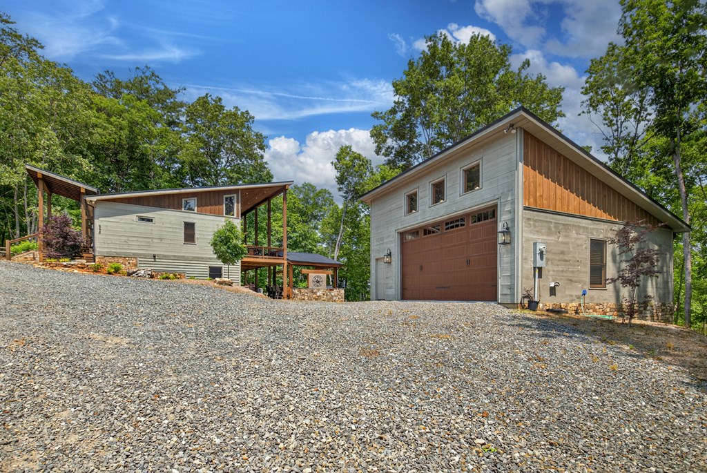 558 Tipton Springs Road Morganton, GA 30560 - Photo 50 of 66 a view of a house with a garage and a yard