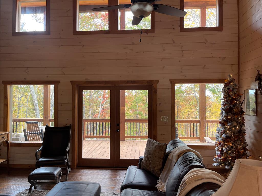 558 Tipton Springs Road Morganton, GA 30560 - Photo 62 of 66 a living room with furniture and a floor to ceiling window