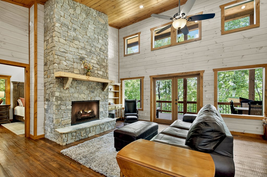 558 Tipton Springs Road Morganton, GA 30560 - Photo 8 of 66 a living room with furniture large window and a fireplace