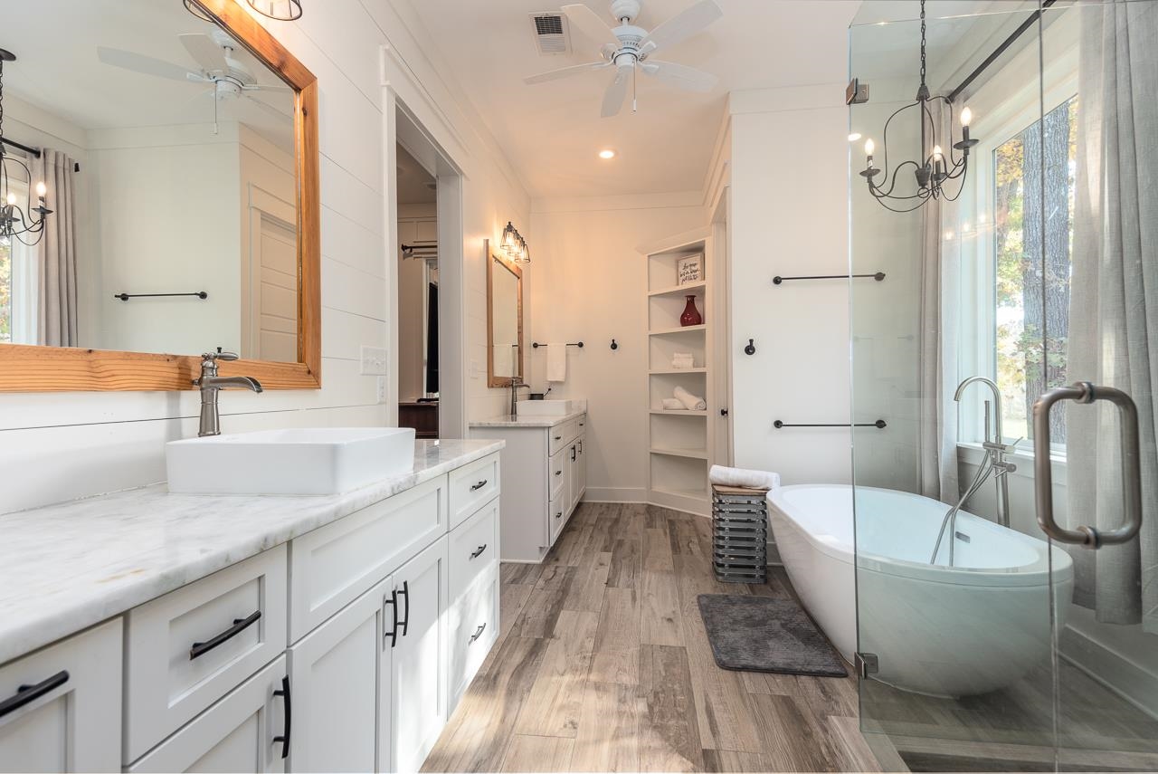 570 Wildwood Road Eads, TN 38028 - Photo 14 of 38 a spacious bathroom with a double vanity sink a mirror and a bathtub