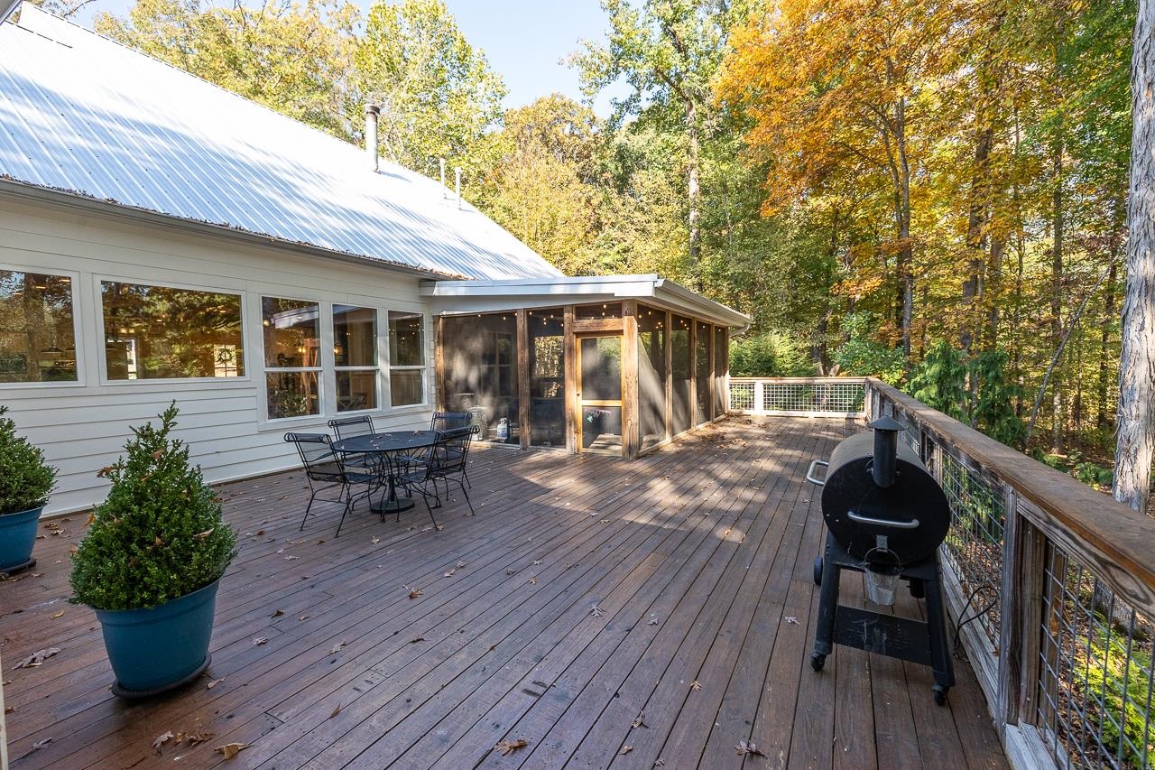 570 Wildwood Road Eads, TN 38028 - Photo 28 of 38 a view of a patio with table and chairs and wooden floor