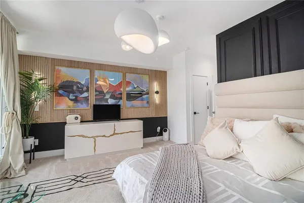 a bedroom with a bed and a chandelier