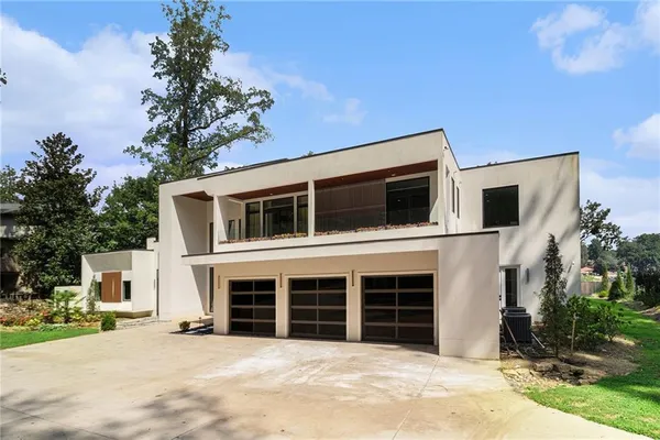 a view of a house with a yard and garage