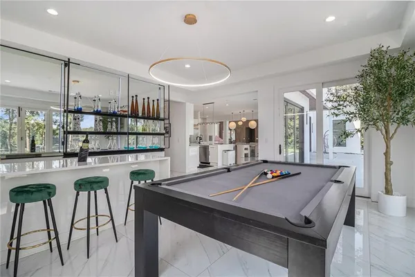 a bedroom with furniture and a large window