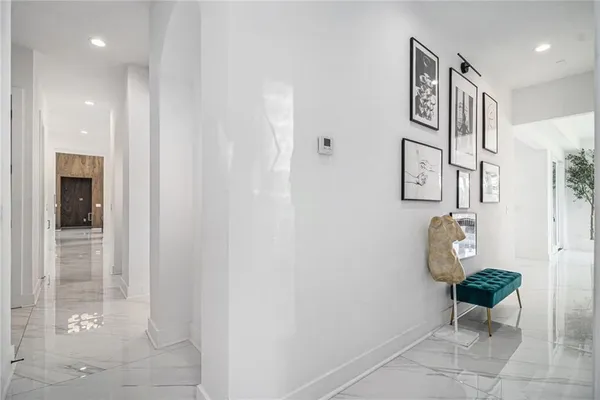 a living room with furniture and large windows