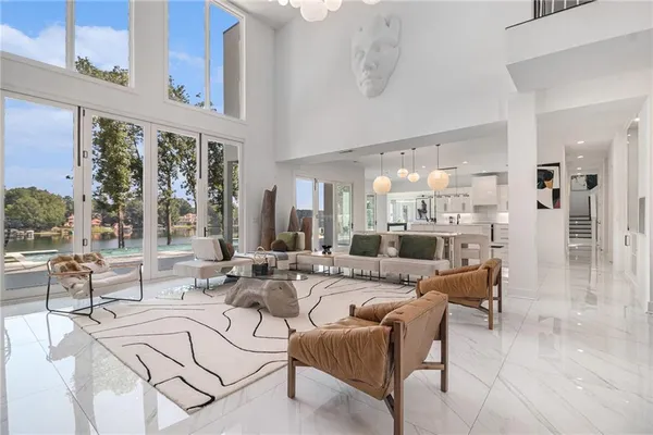 a living room with furniture potted plant and a large window