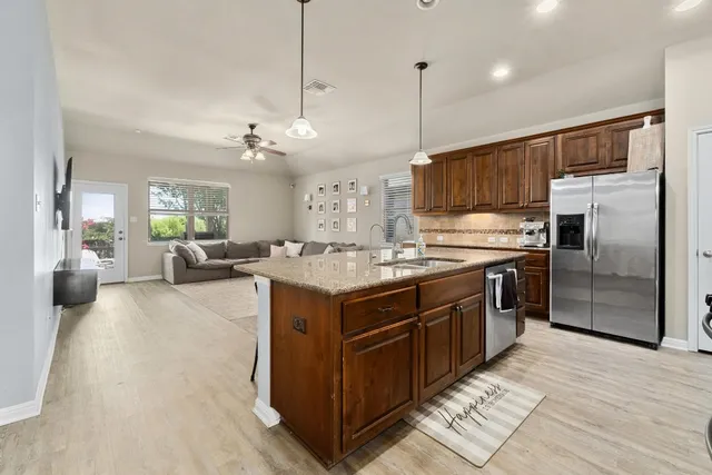 a kitchen with a sink stove and refrigerator