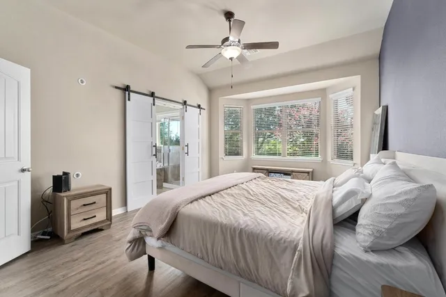 a bedroom with a bed dresser and a window