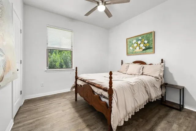 a bed sitting in a bedroom next to a window