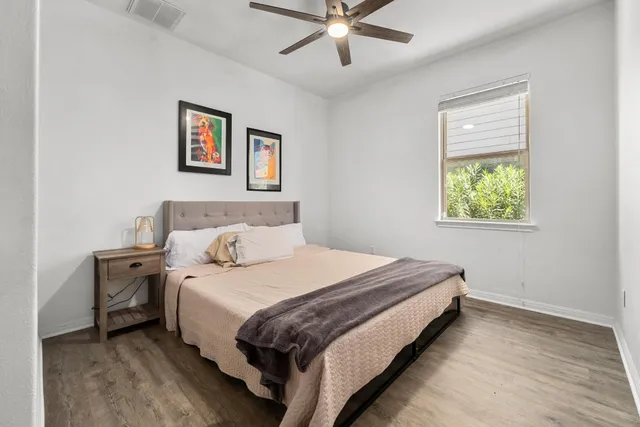 a bedroom with a bed and painting on the wall
