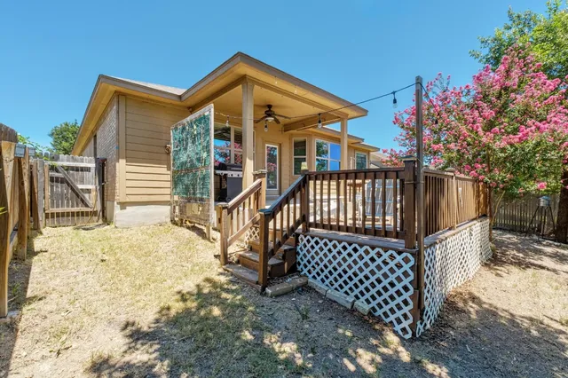 a view of a brick house with wooden fence