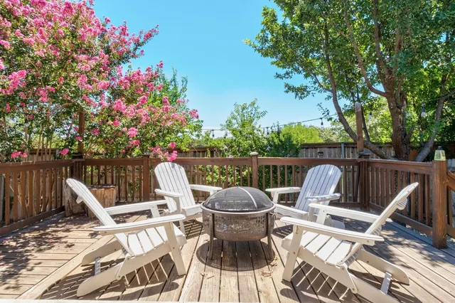 a view of a chairs and tables in the roof deck