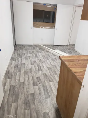 a view of a utility room with wooden floor