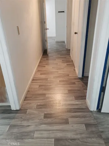 a view of a hallway with wooden floor
