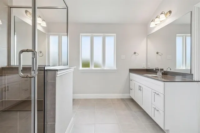 a bathroom with a double vanity sink and mirror