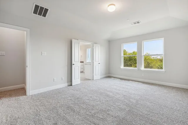an empty room with windows and closet