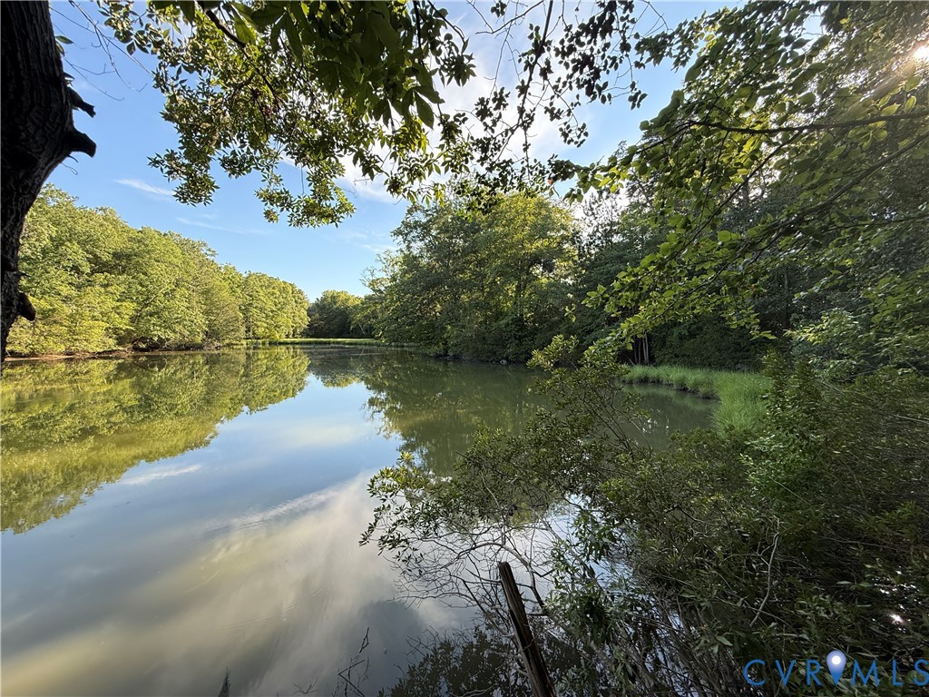 88 Seahawk Road Urbanna, VA 23175 - Photo 4 of 16 Serene pond with reflective surface and surroundin
