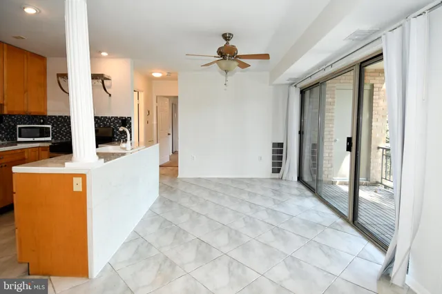 a view of a living room with a ceiling fan