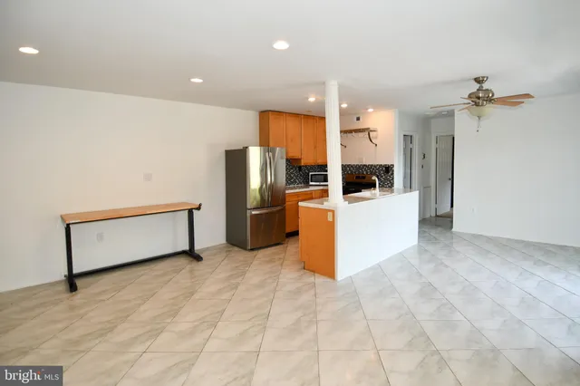 a kitchen with stainless steel appliances a refrigerator and a stove