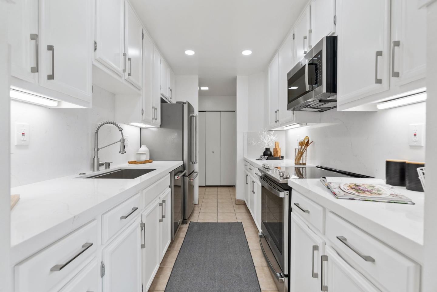 1020 Shoreline Drive San Mateo, CA 94404 - Photo 13 of 46 a kitchen with stainless steel appliances granite countertop a sink stove and refrigerator
