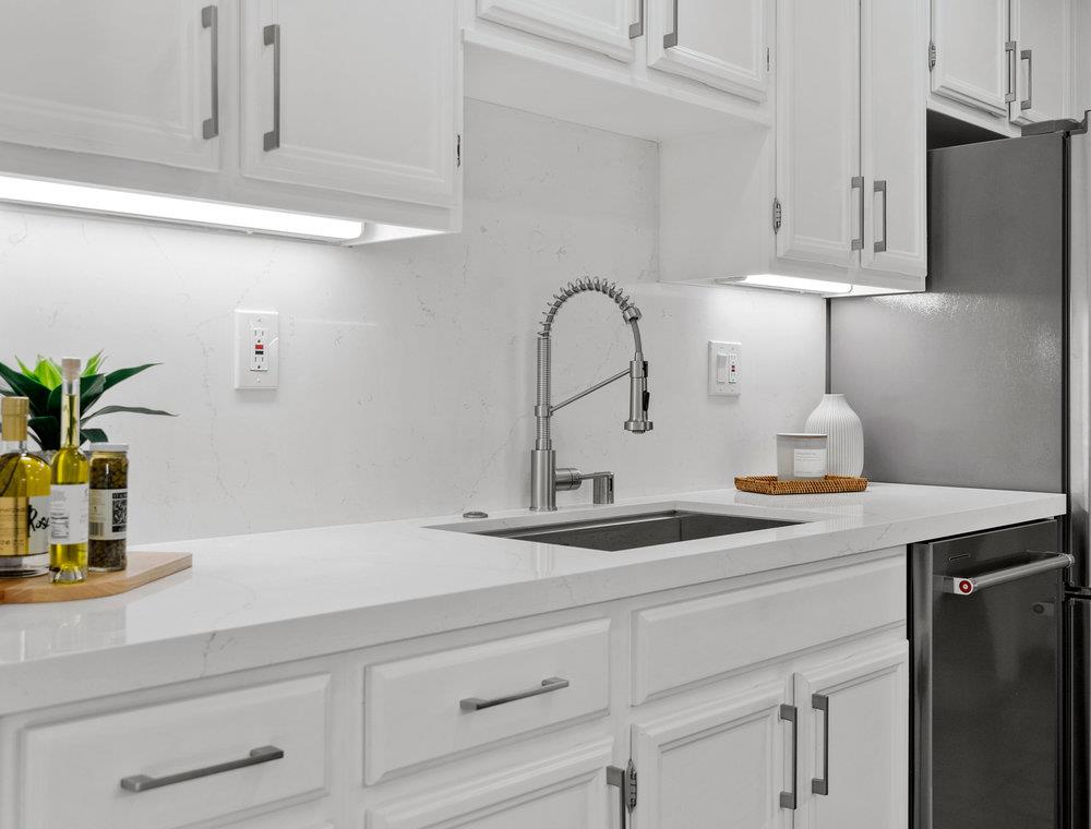 1020 Shoreline Drive San Mateo, CA 94404 - Photo 14 of 46 a kitchen with white cabinets and a sink