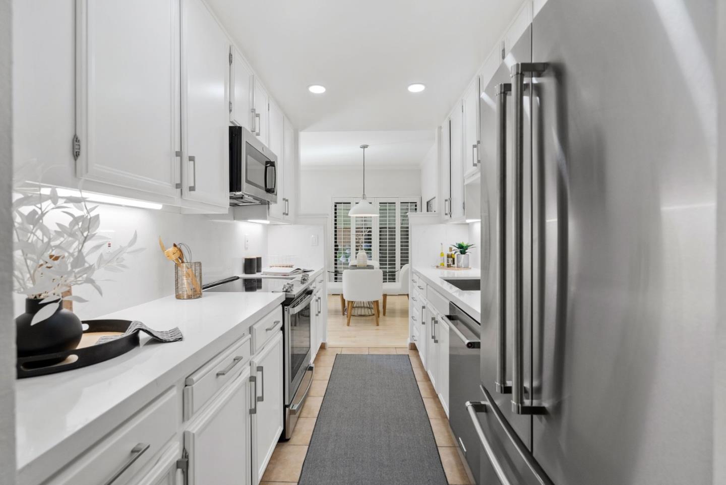 1020 Shoreline Drive San Mateo, CA 94404 - Photo 16 of 46 a kitchen with white cabinets and stainless steel appliances